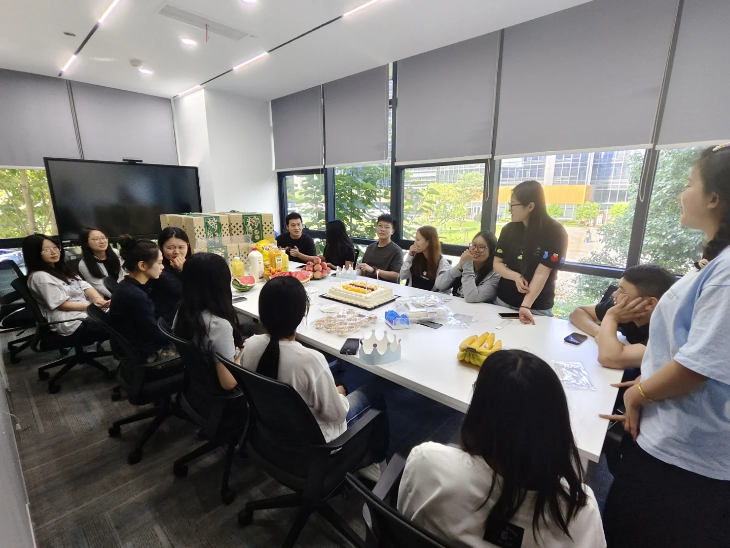 KEEYAK colleagues sharing a Dragon Boat Festival gathering around the office table