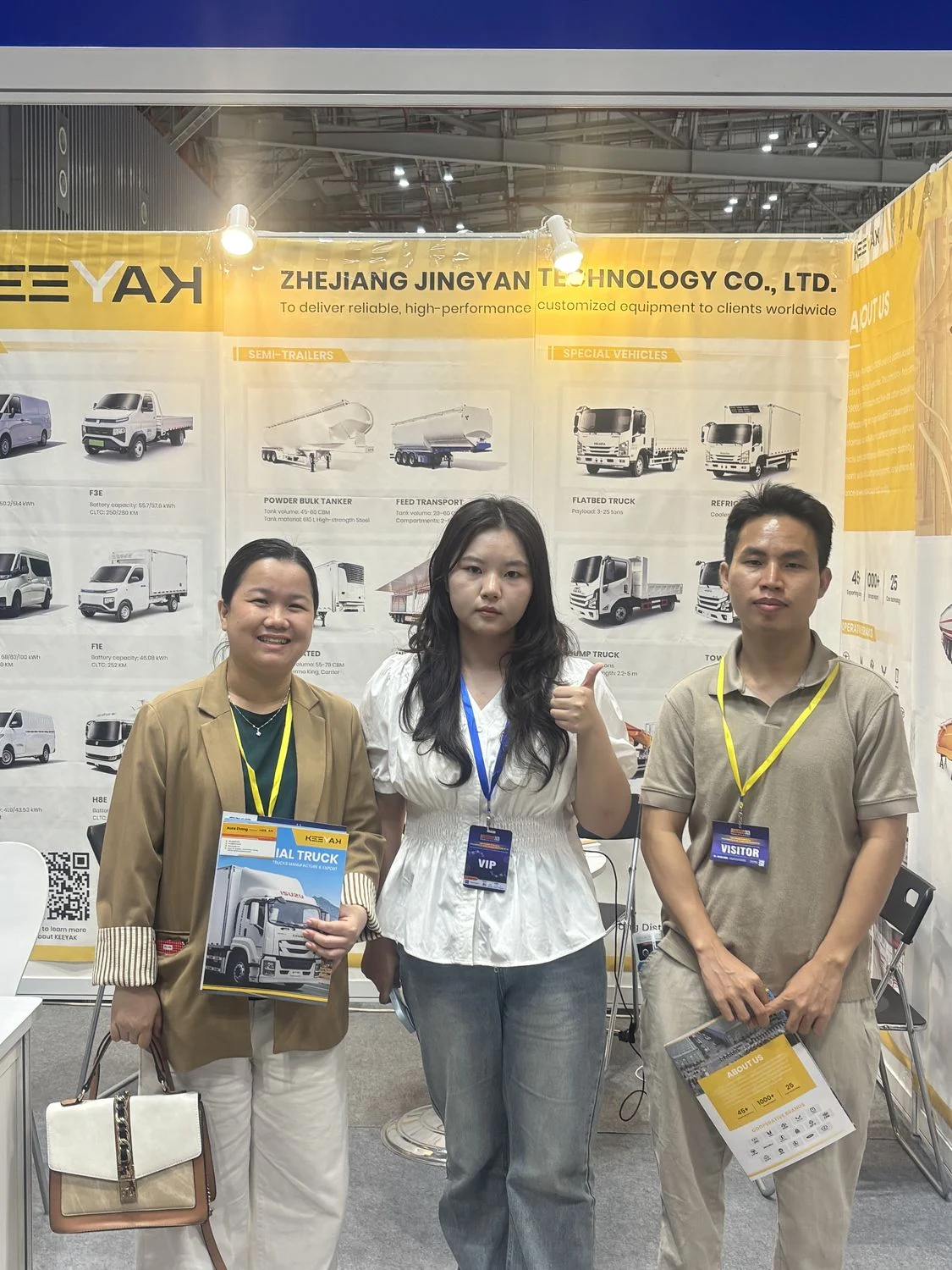KEEYAK team and visitors with vehicle brochures at the Vietnam exhibition
